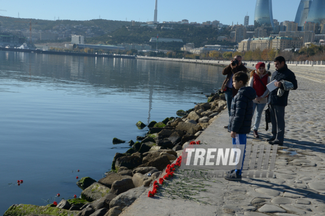 Baku residents bringing flowers to Seaside Boulevard to honor missing oil workers.  Azerbaijan, Dec.07, 2015